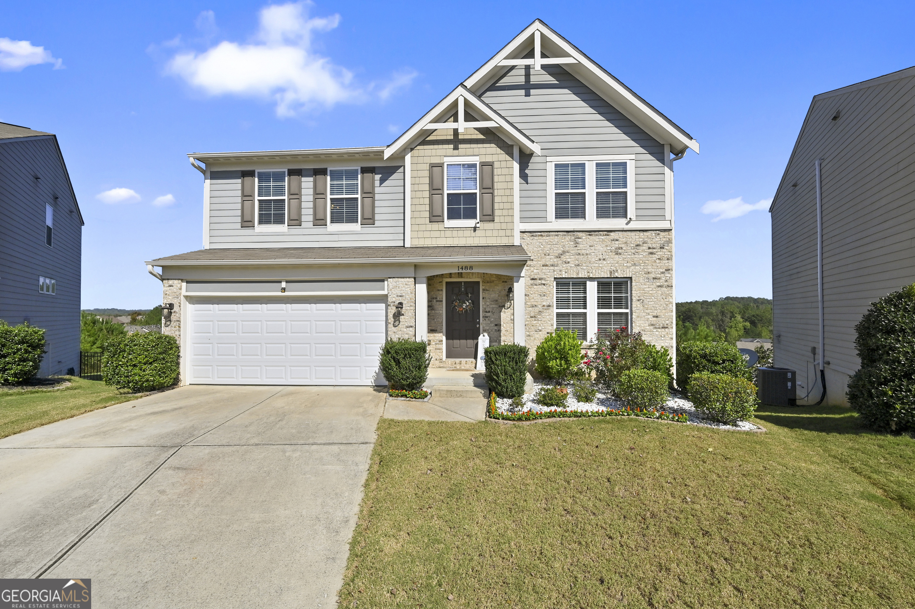 a front view of a house with a yard and garage