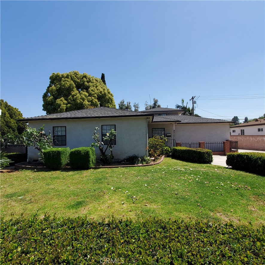 a view of a house with a yard and sitting area