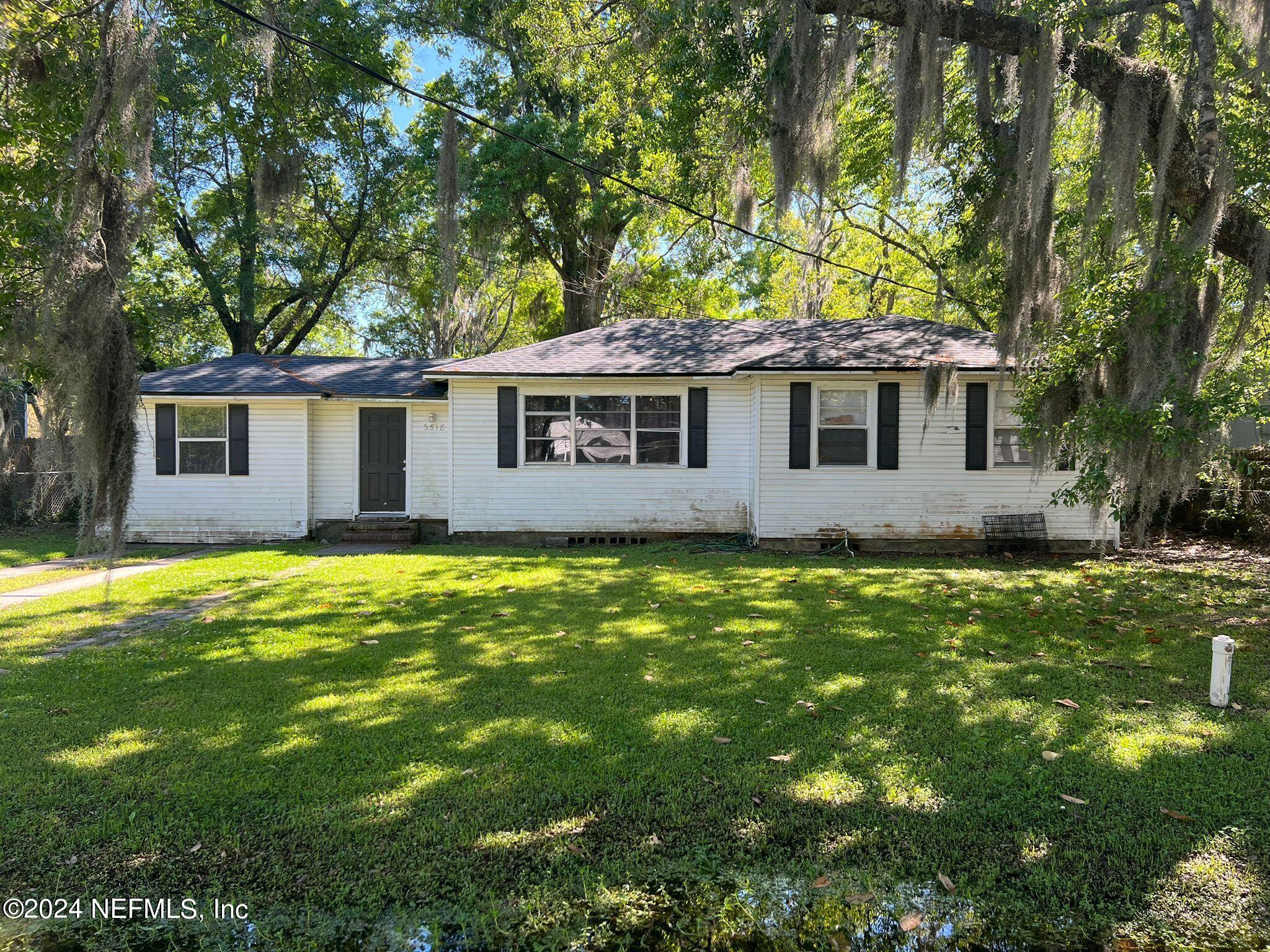 a front view of house with yard and green space