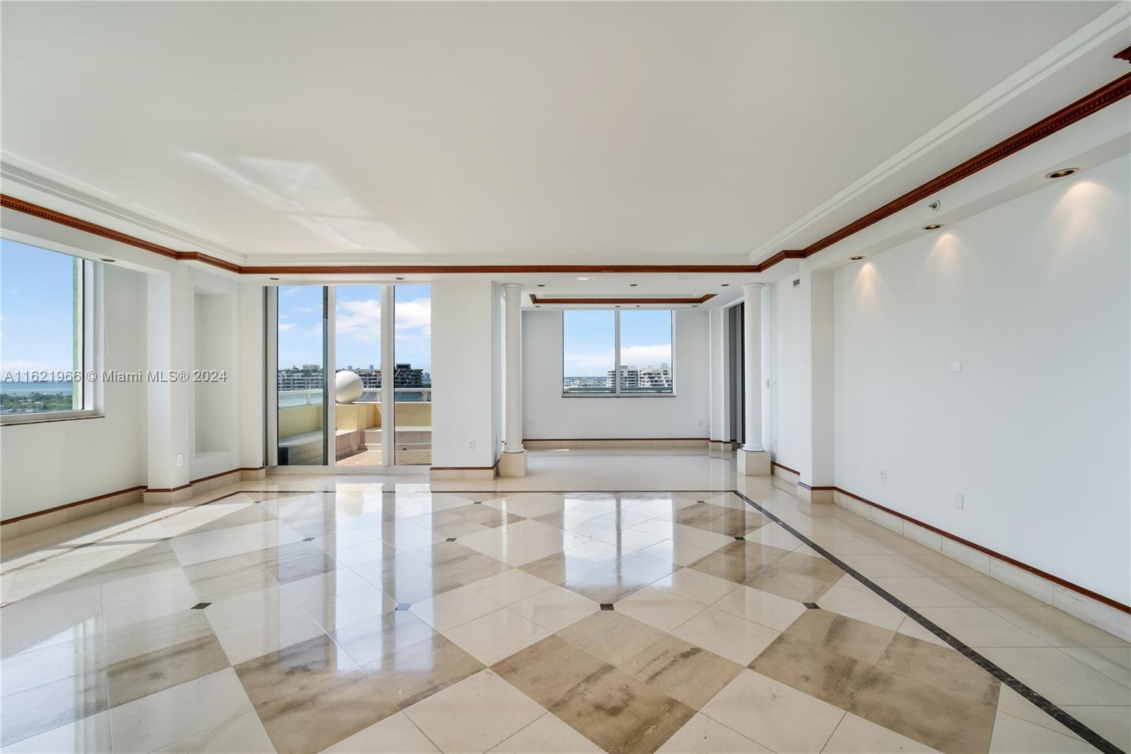 a large white room with windows and chandelier