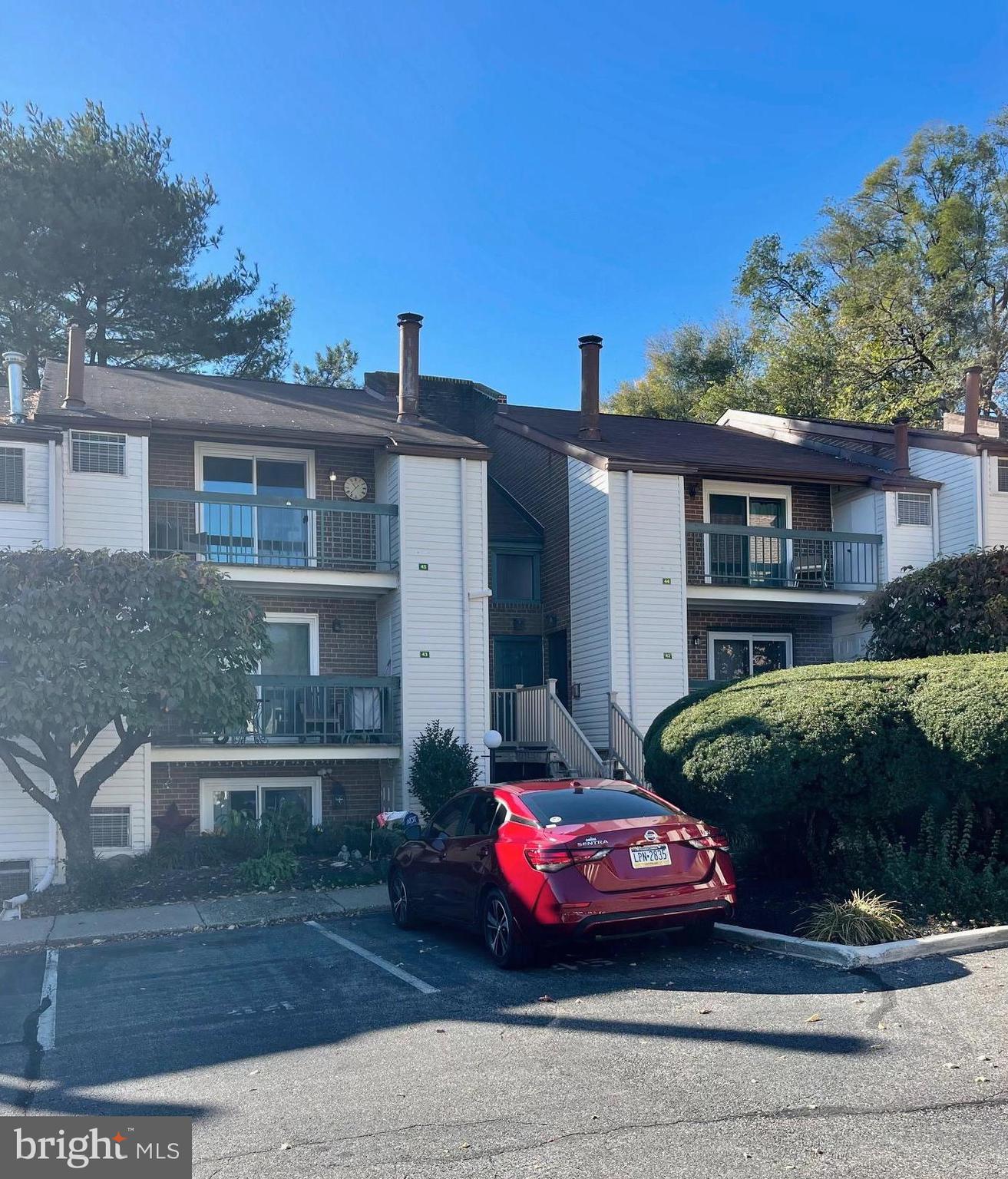 a front view of a house with parking space