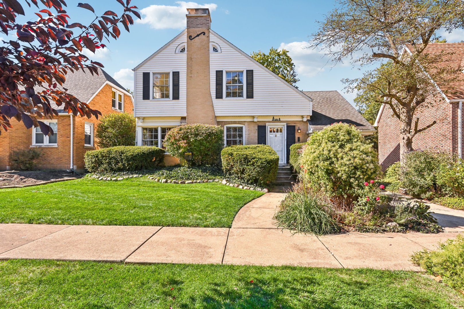 a front view of a house with a garden