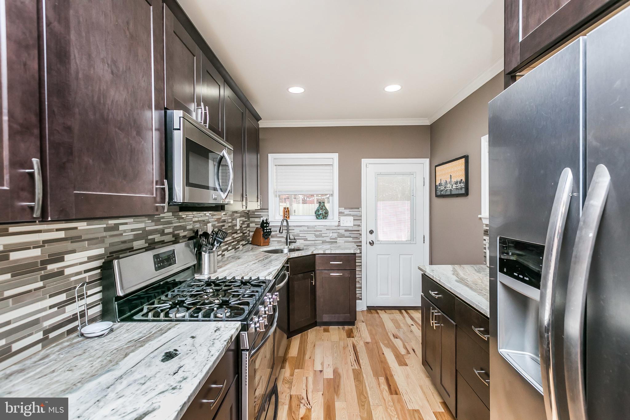 a kitchen with a refrigerator stove and sink