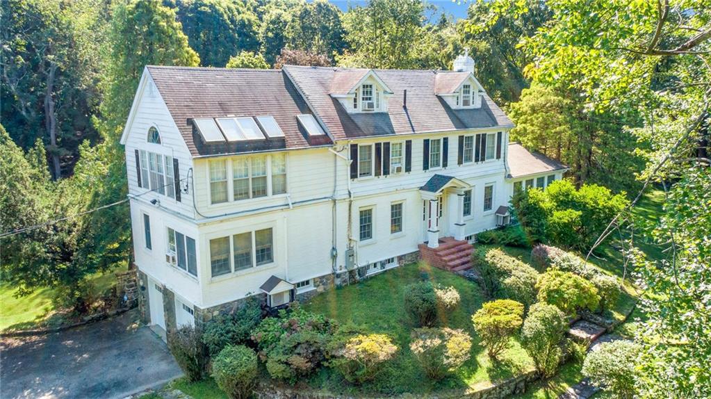 a aerial view of a house with a yard and garden