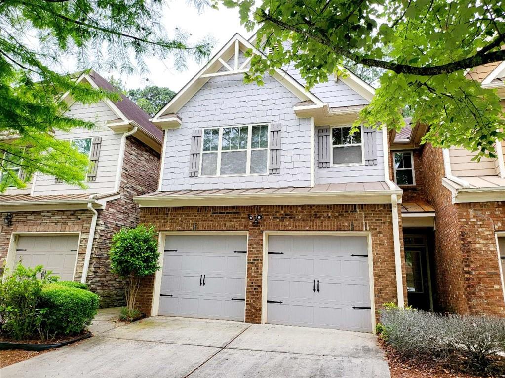 front view of a house with a tree