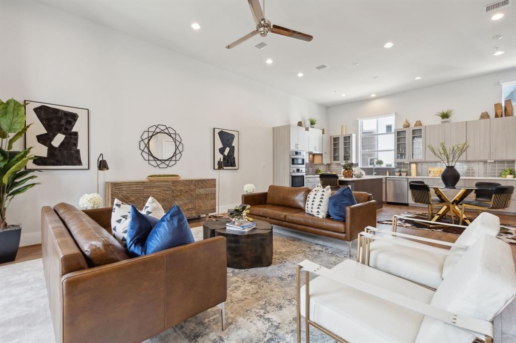 a living room with furniture and kitchen view