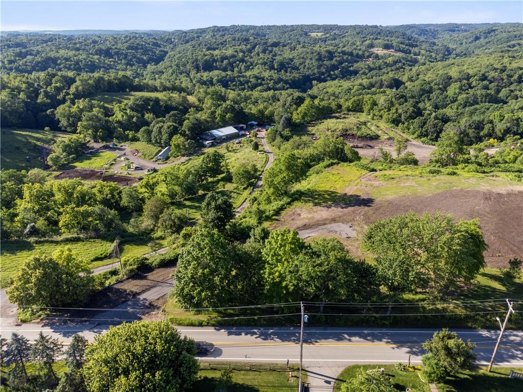 an aerial view of a houses with a yard