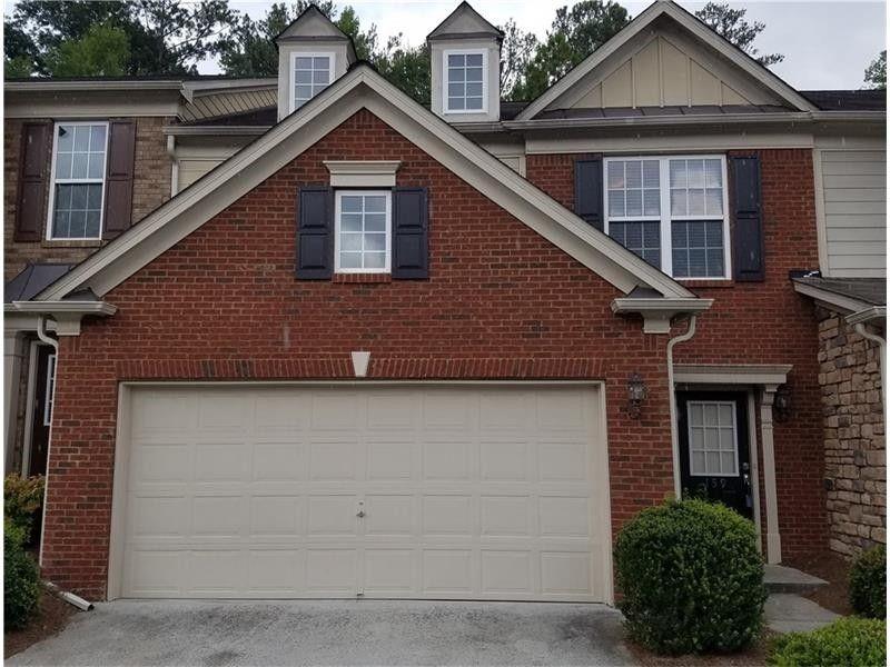 a front view of a house with garage