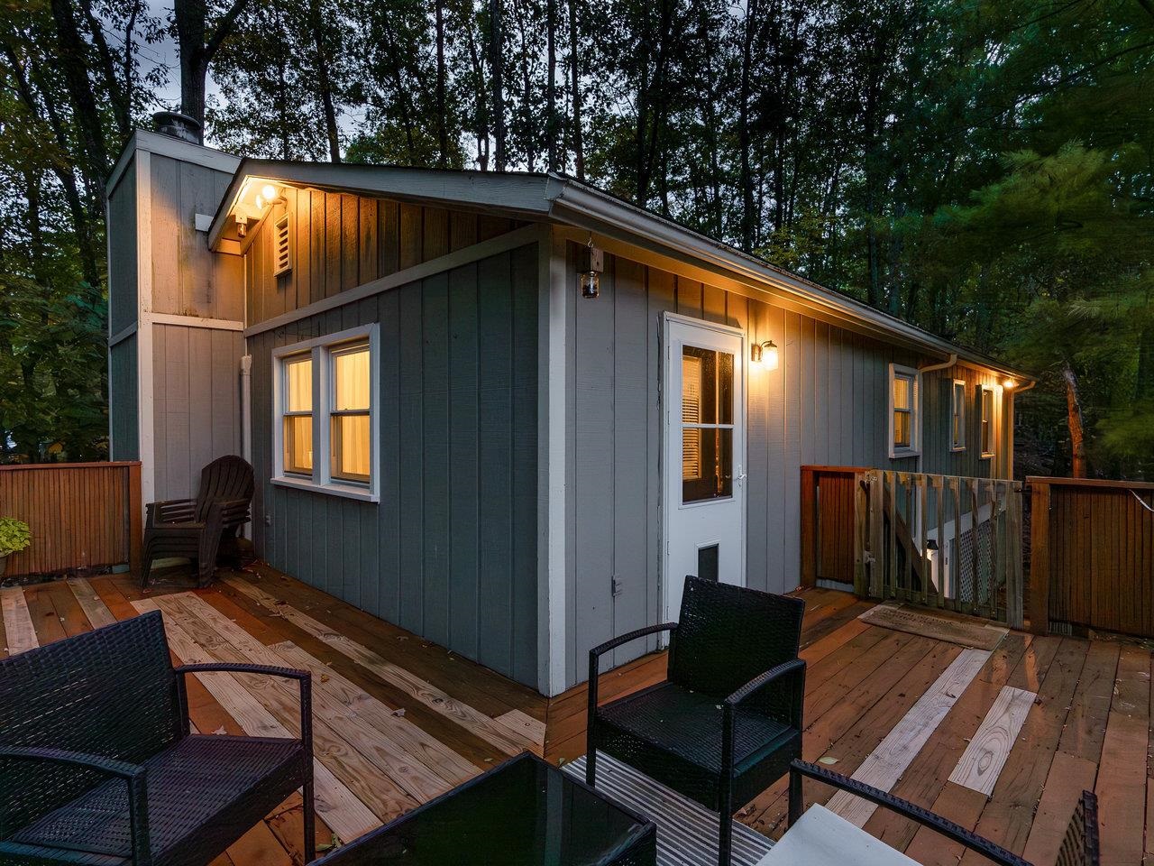 a view of backyard with deck and outdoor seating