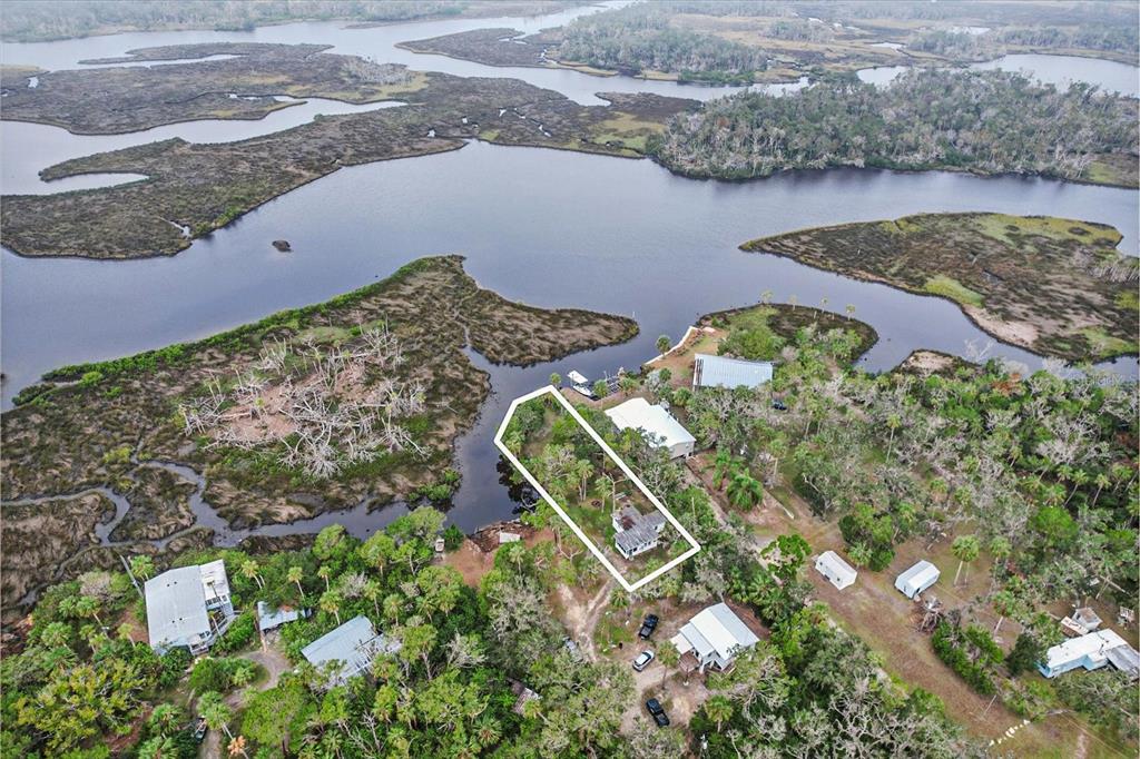 an aerial view of a house with a lake view