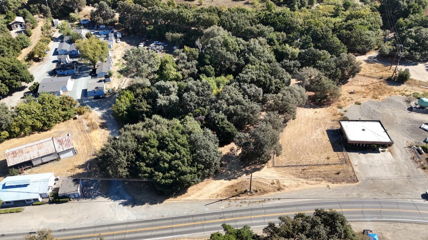 an aerial view of a house with a yard and parking