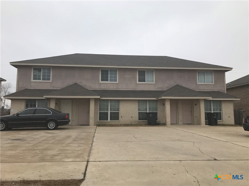 a front view of a house with parking