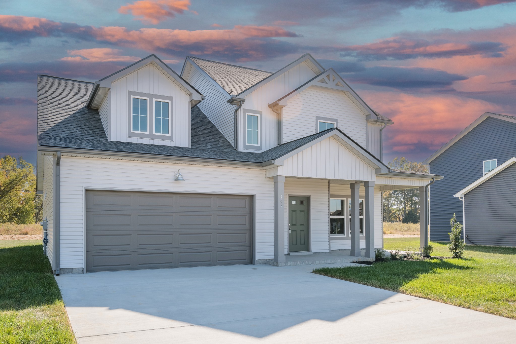 a front view of a house with a yard and garage