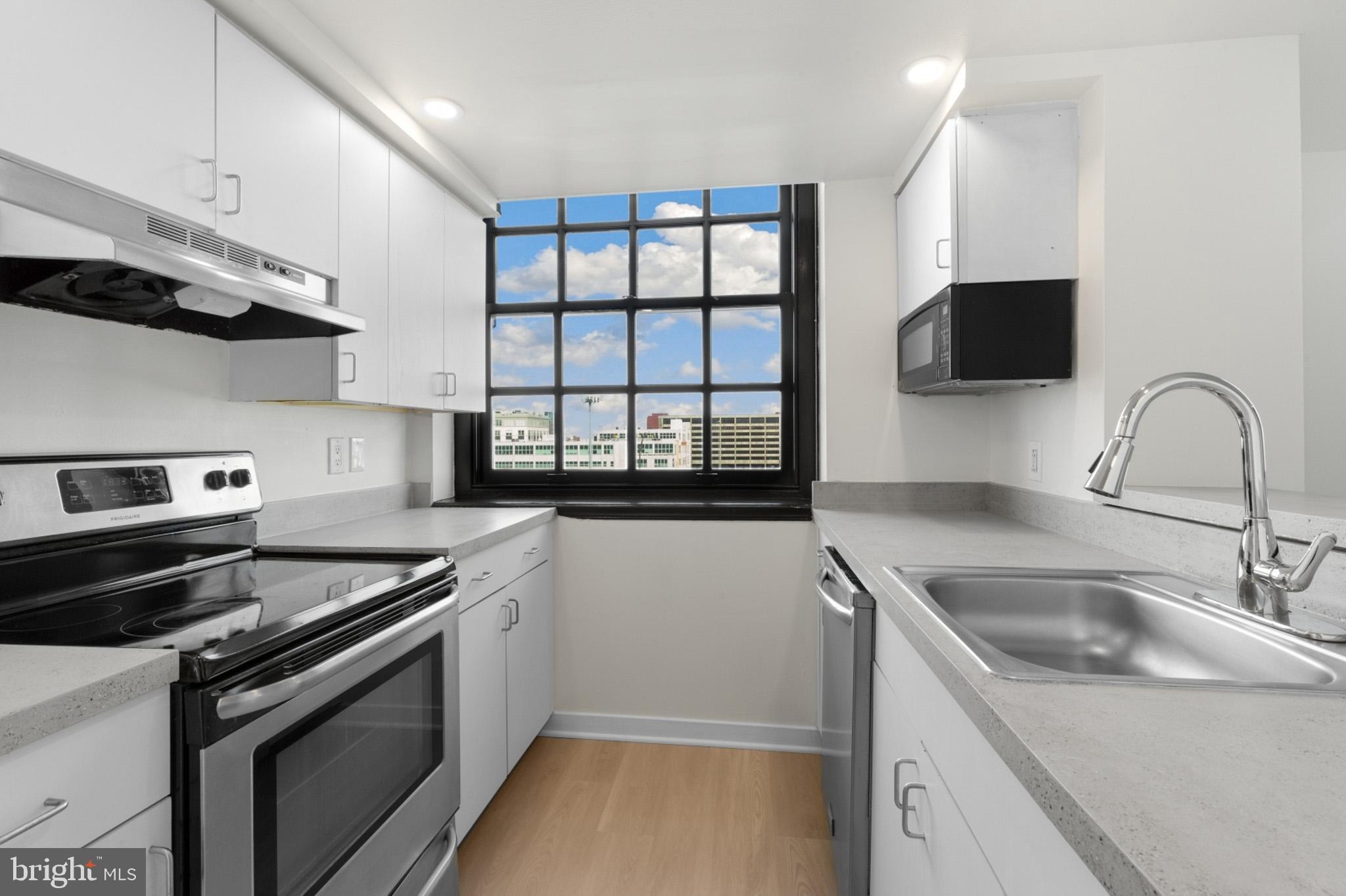 a kitchen that has a sink and a stove