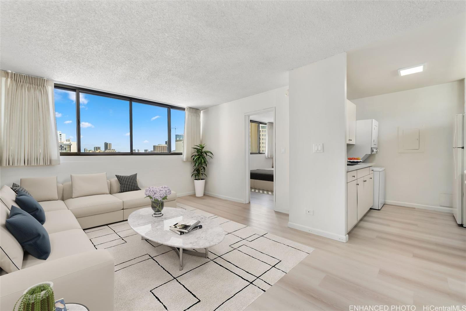 a living room with furniture and kitchen view