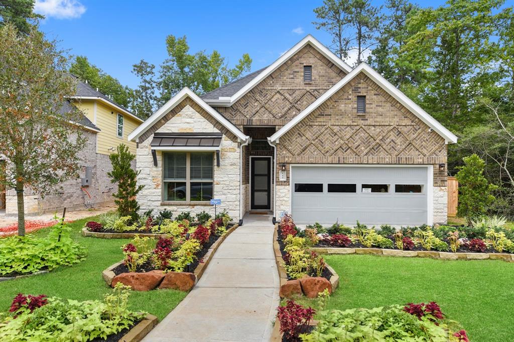 a front view of a house with a garden and plants