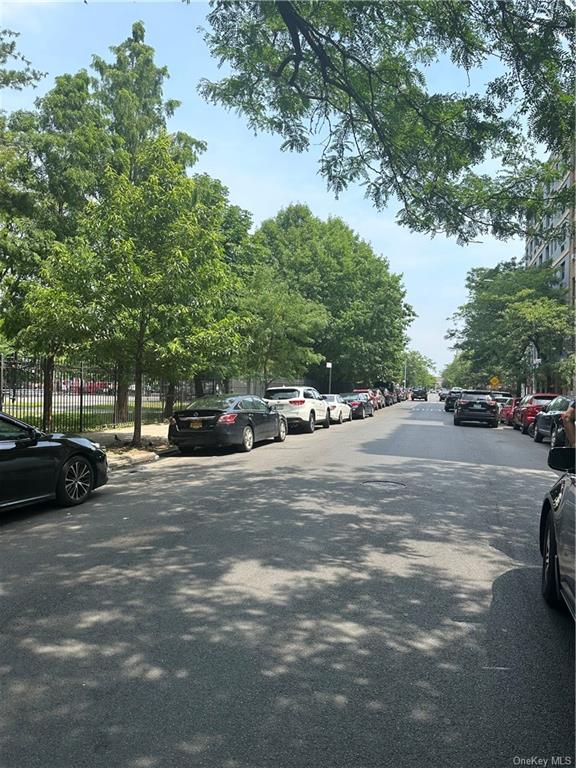 a view of street with parked cars