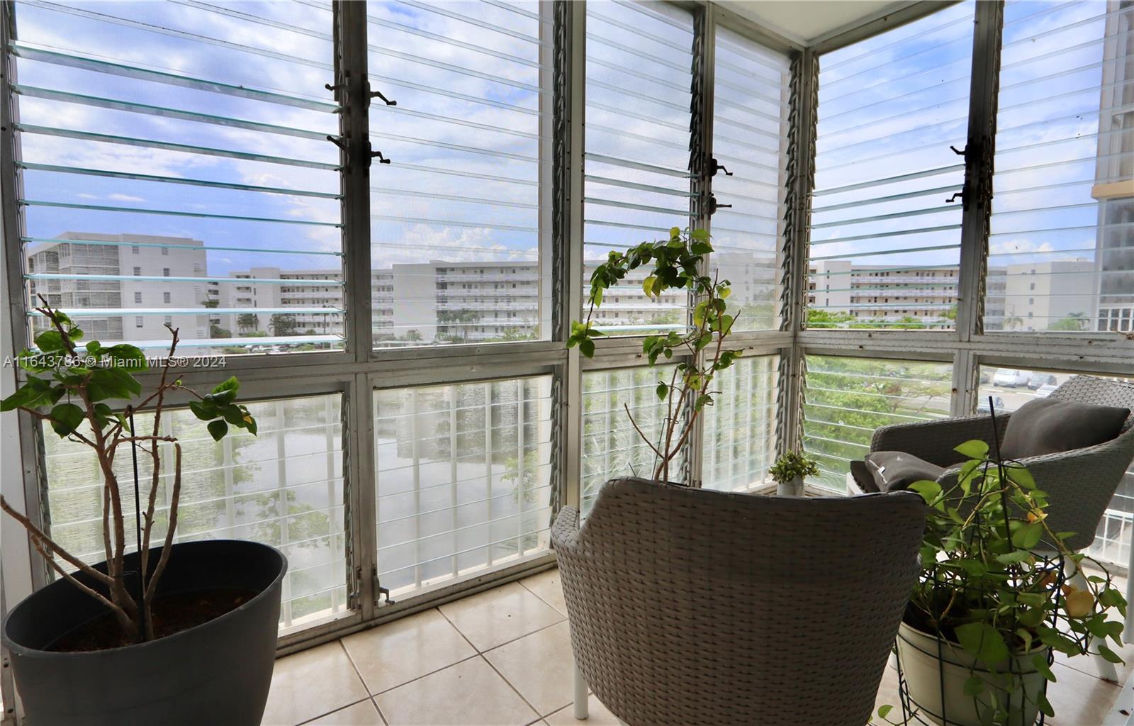 a living room filled with furniture and a potted plant