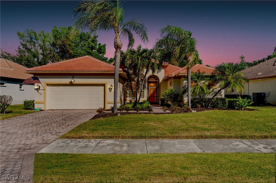 a view of a house with a swimming pool and a yard