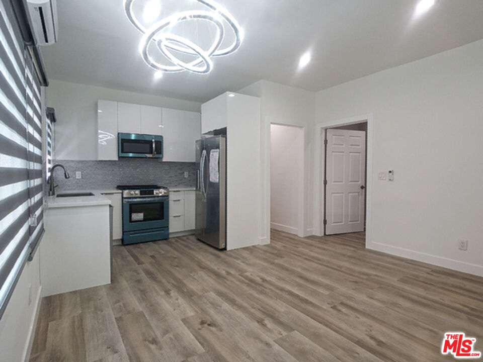 a kitchen with stainless steel appliances a refrigerator sink and stove