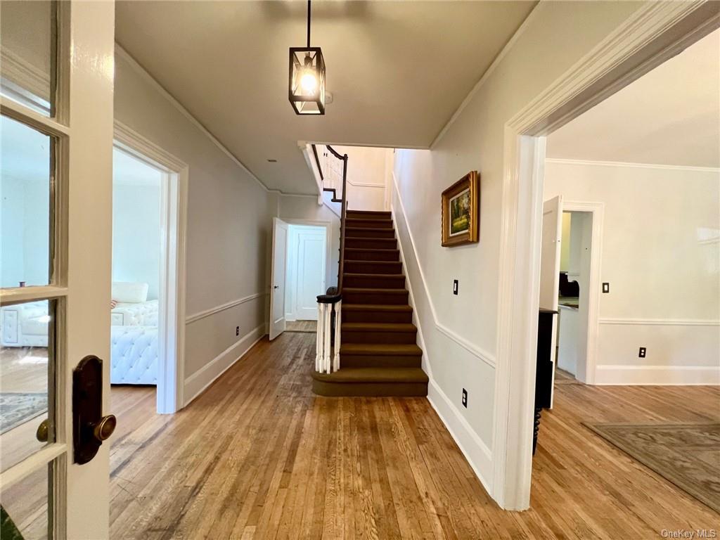 a view of a hallway view with wooden floor and staircase