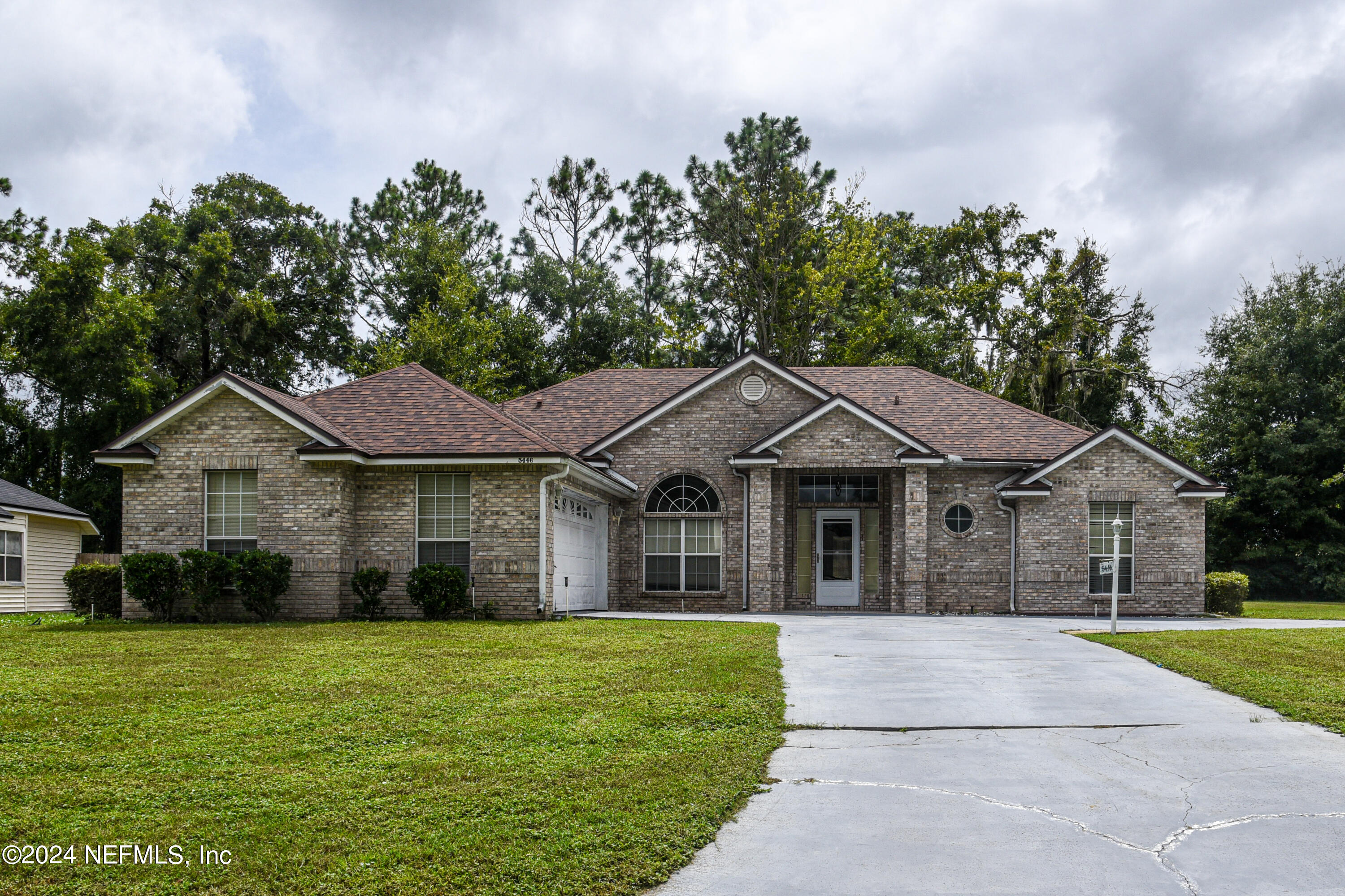 a front view of a house with a garden