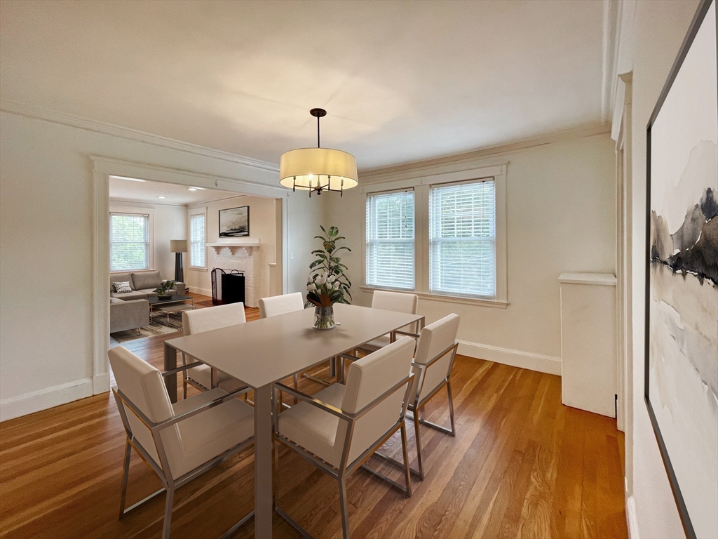 a view of a dining room with furniture and a chandelier