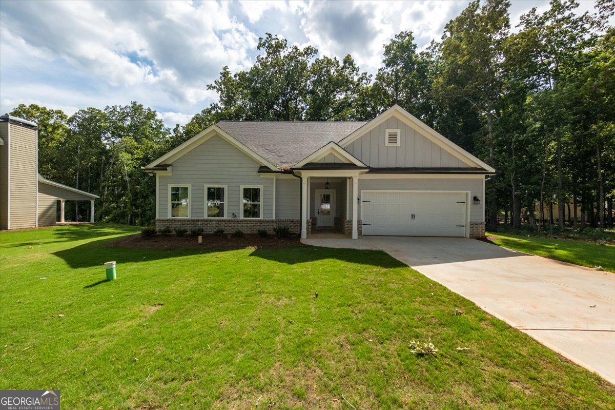 a front view of a house with yard and green space