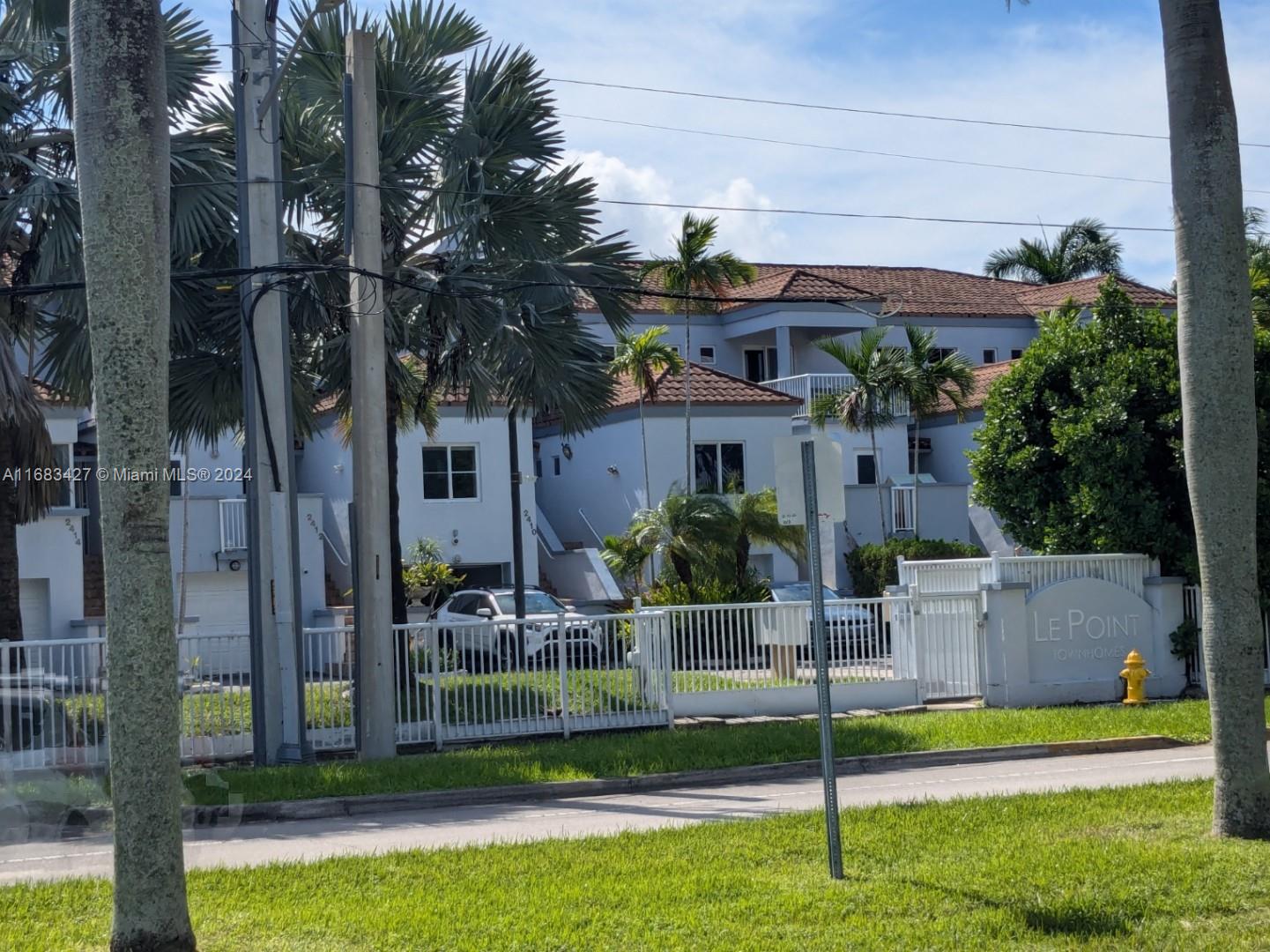 a view of a house with a yard and plants