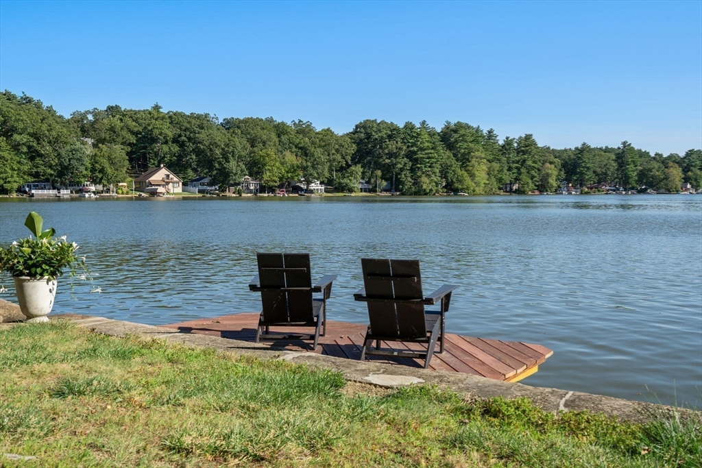 a view of a lake with wooden deck and lake