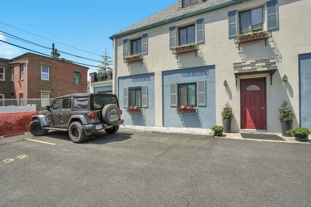 a view of a car parked in front of a building