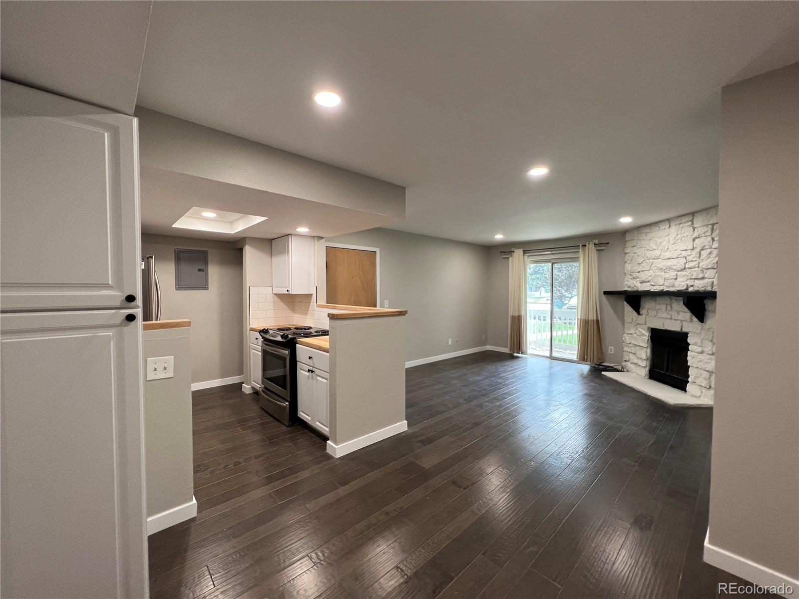 a view of kitchen with sink and refrigerator