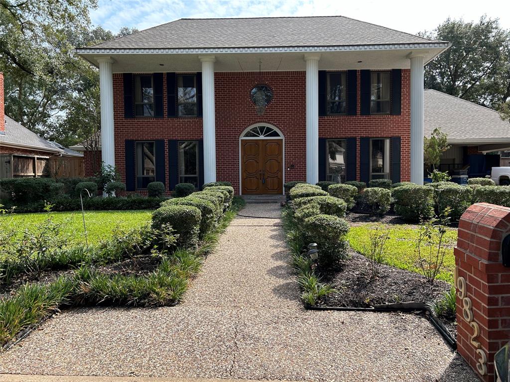 a front view of house with outdoor seating and yard