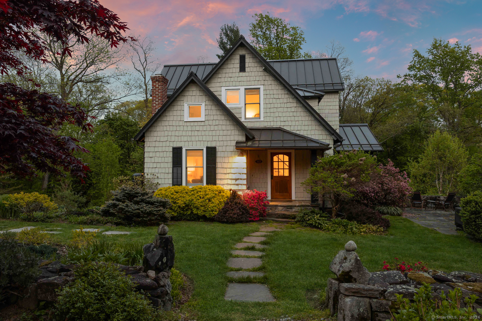 a front view of house with a garden