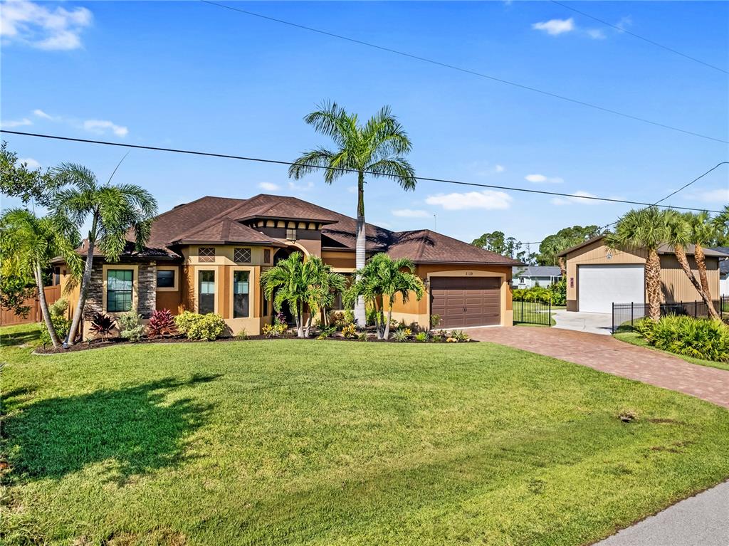 a view of a big house with a big yard and potted plants