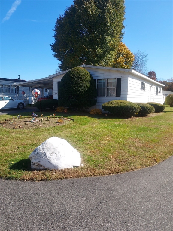 a view of a house with swimming pool and a yard