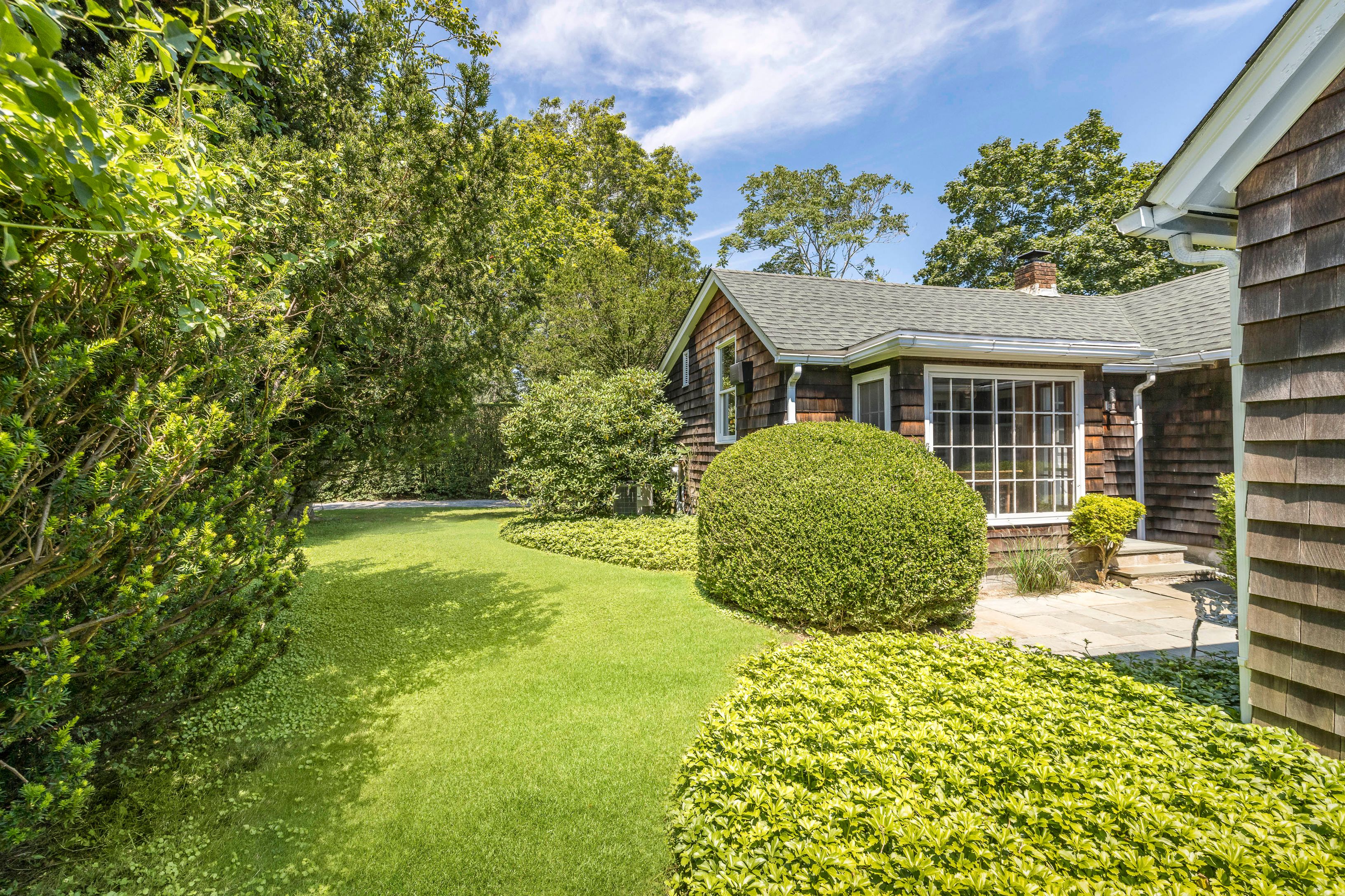 a view of a house with a backyard and a garden