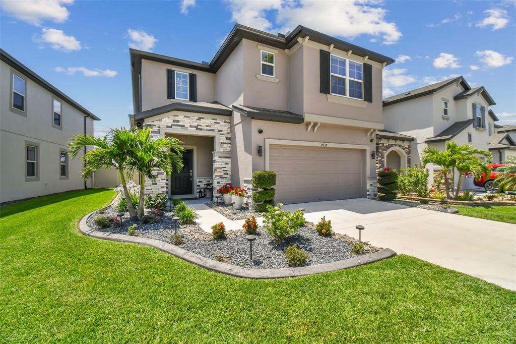 a view of a house with a yard patio and fire pit