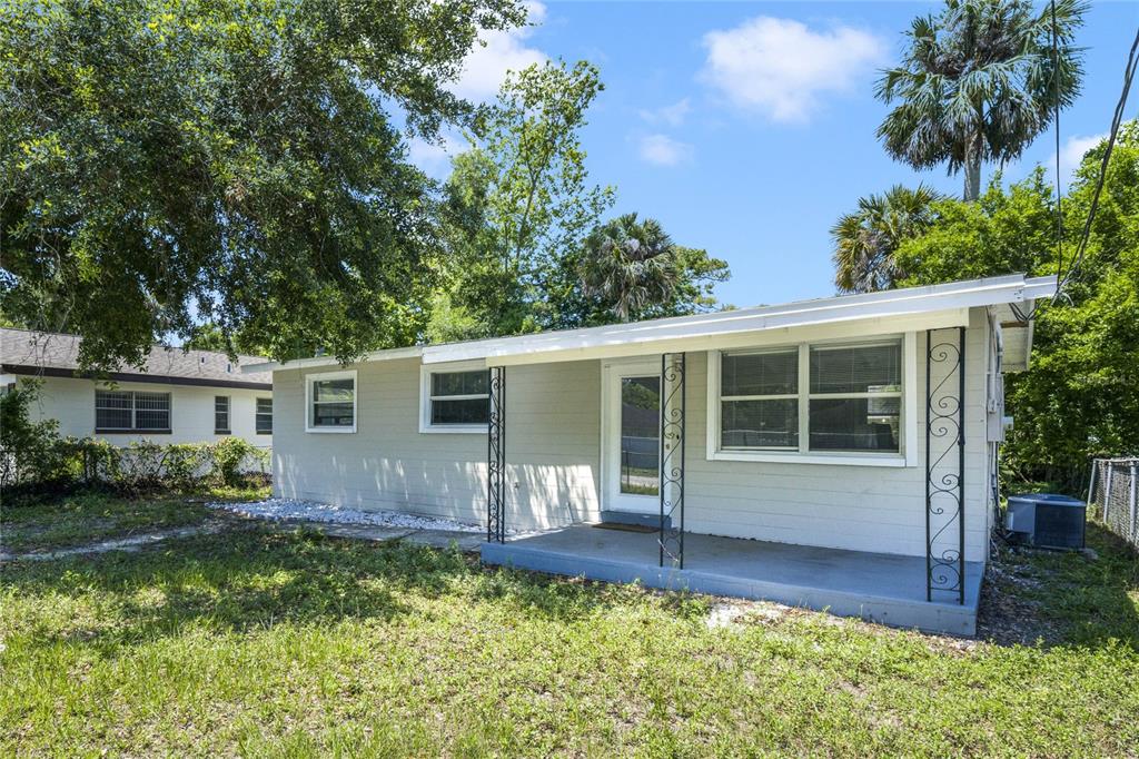 a front view of house with yard and outdoor seating