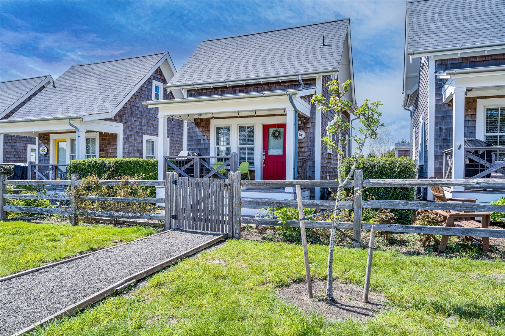 a view of house with a backyard and a patio