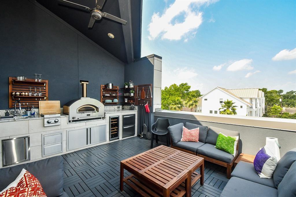 a living room with furniture a kitchen view and a fireplace