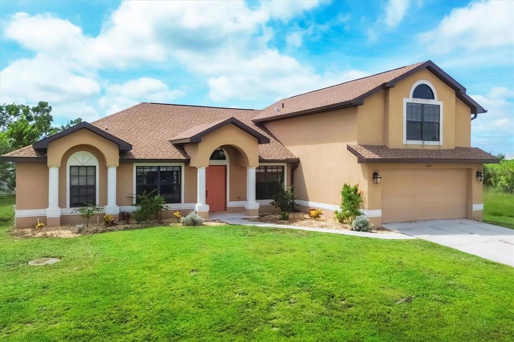 a front view of house with yard and green space