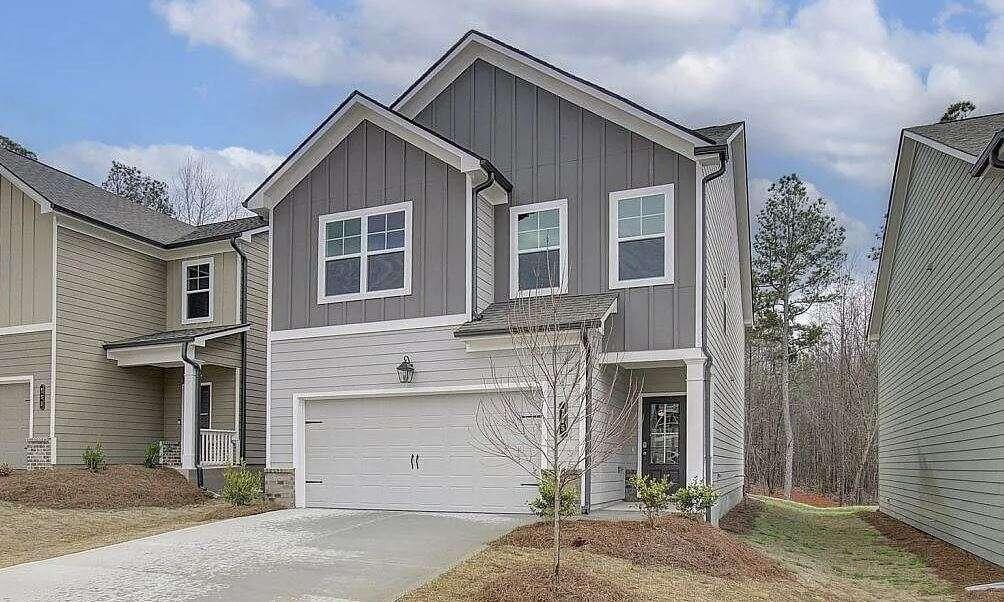 a front view of a house with a yard and garage