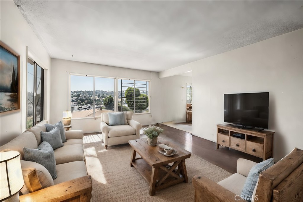 a living room with furniture and a flat screen tv