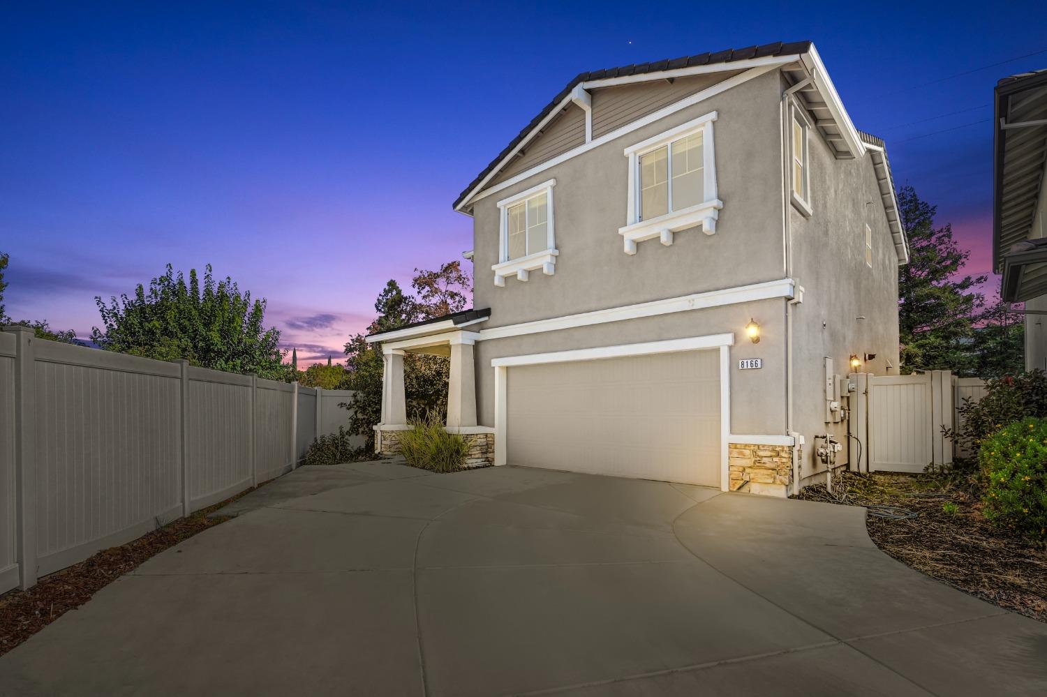 a view of a house with a yard and garage