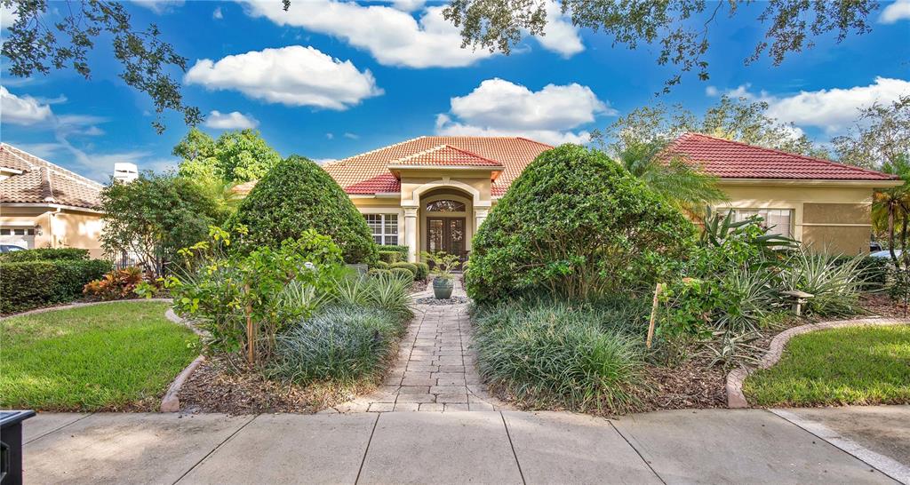 a front view of a house with garden