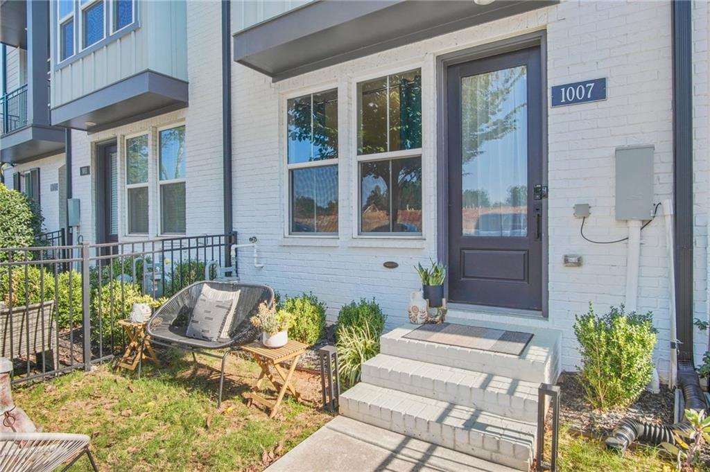 a front view of a house with outdoor seating