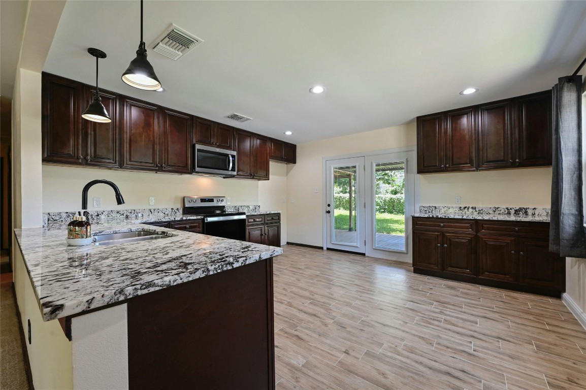 a kitchen with sink cabinets and appliances