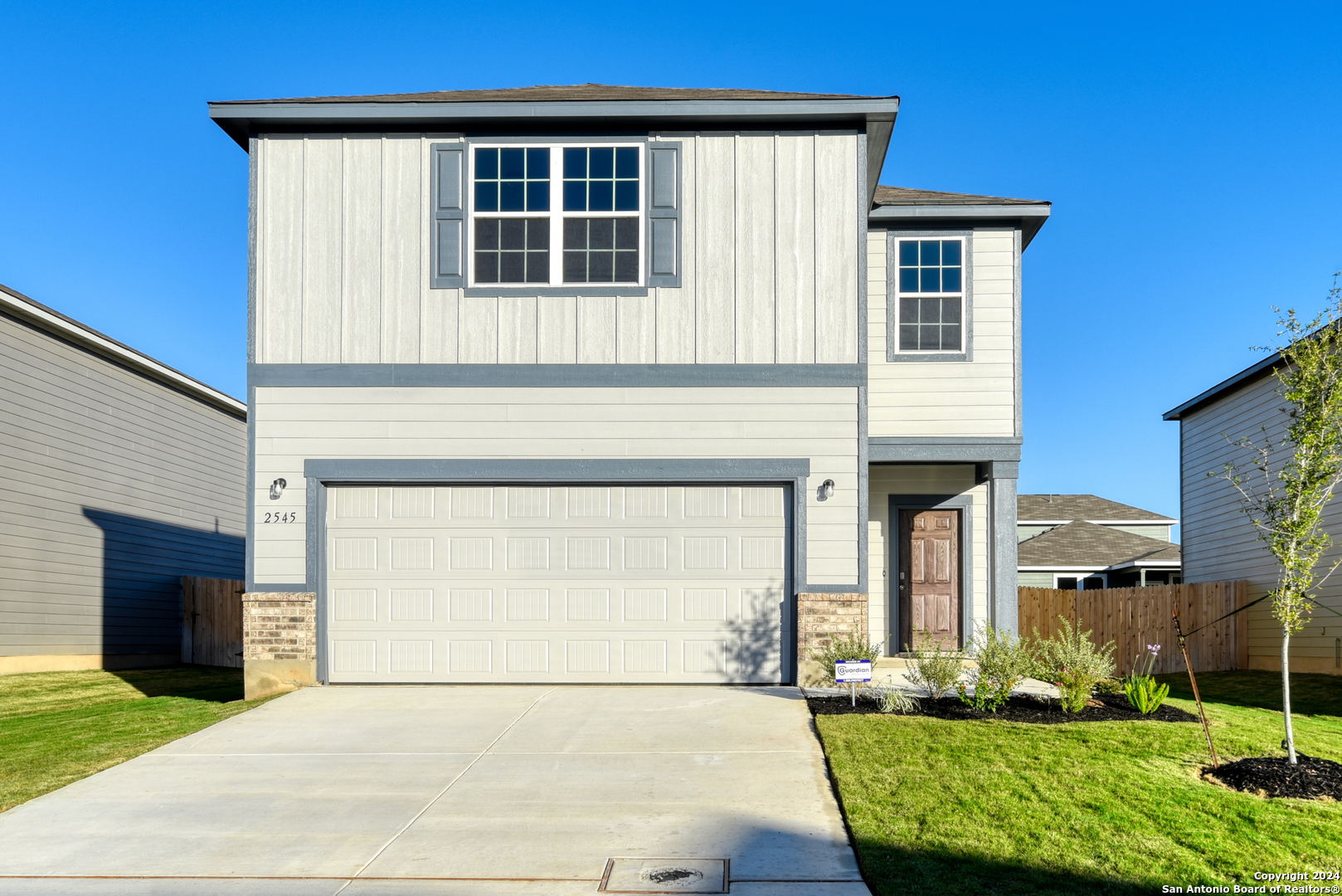 a front view of a house with a yard and garage