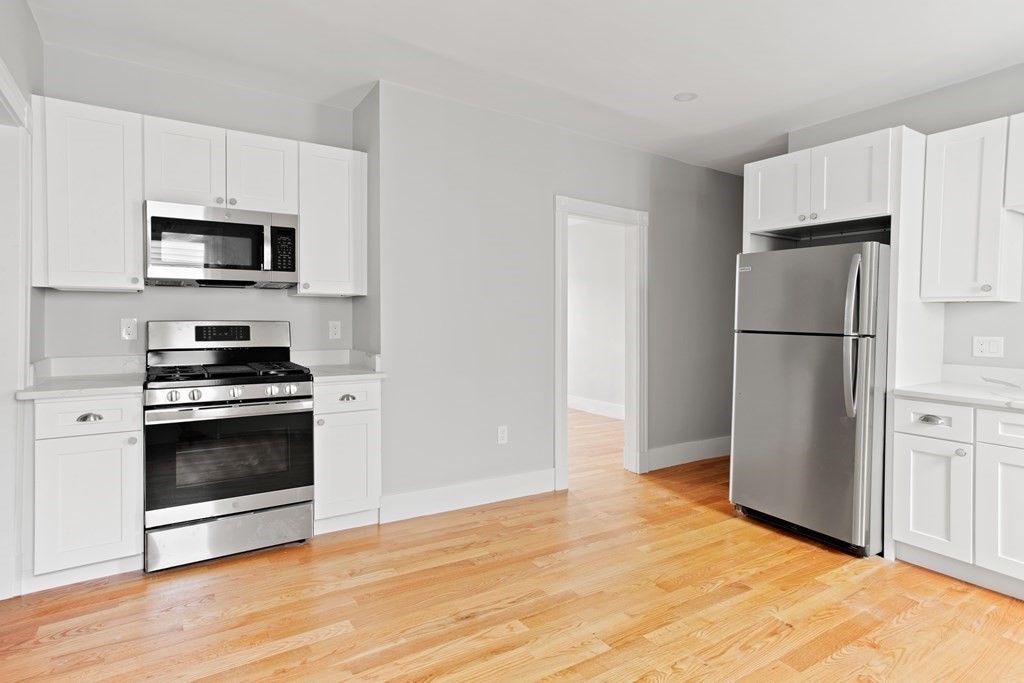 a kitchen with a refrigerator and a stove